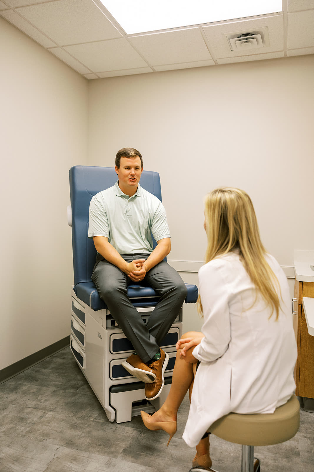 Dr. Sarah Wilson with a patient in an exam room at Newnan Dermatology