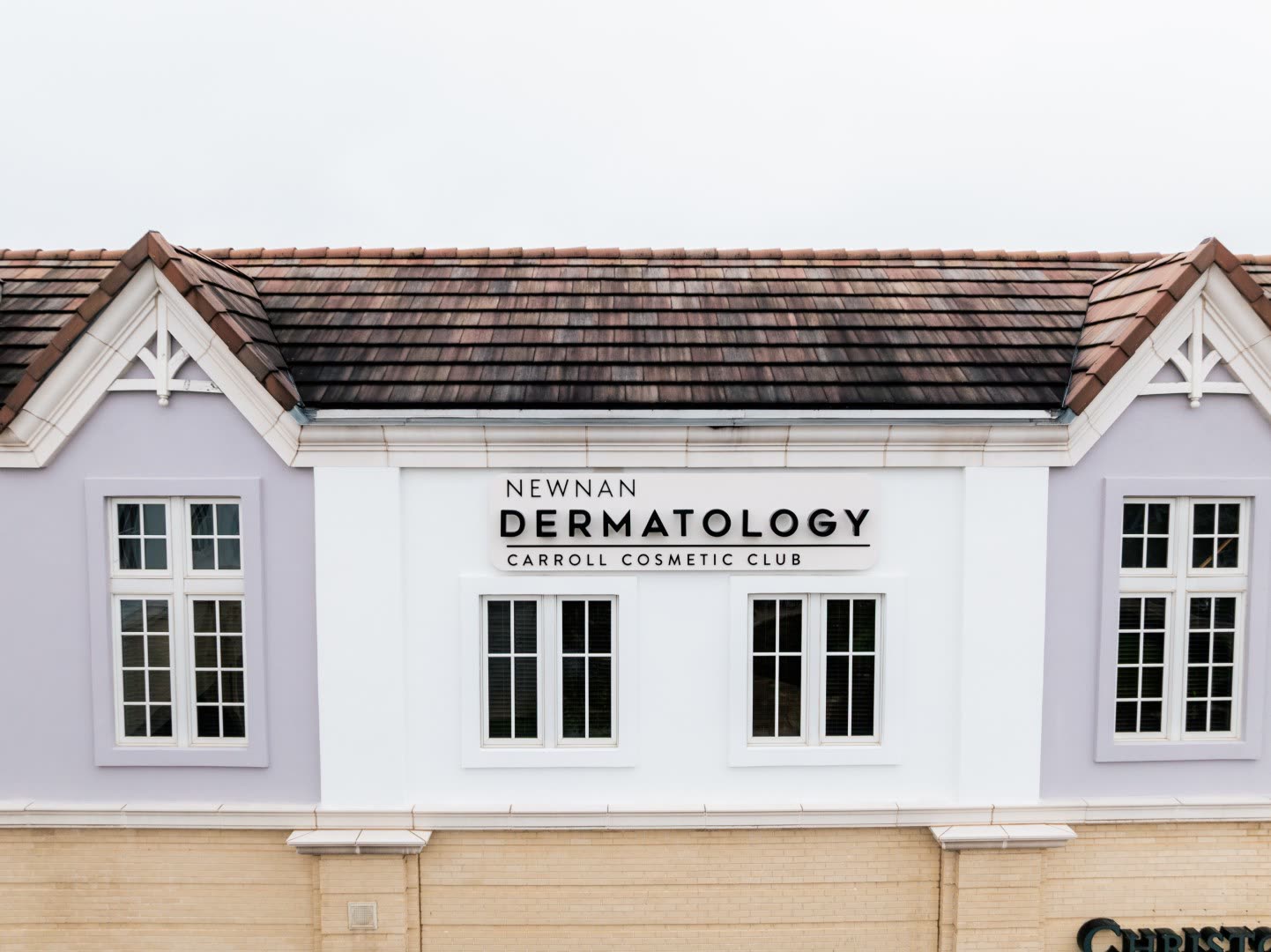 The Newnan Dermatology and Carroll Cosmetic Club sign on the Ashley Park building