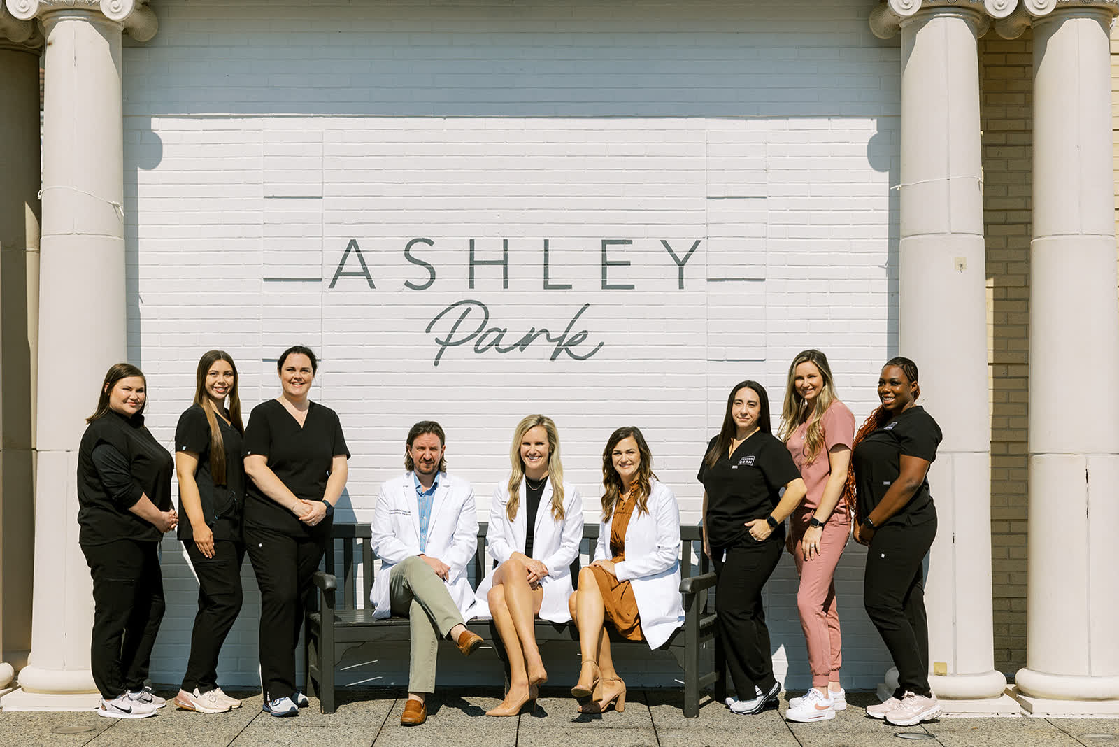 The Newnan Dermatology team in front of the Ashley Park sign